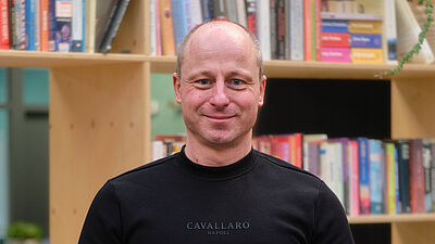 portret van een man in zwart shirt.